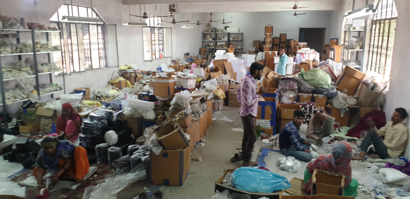 Artisans packing finished brass pieces in the Brass Orchard dispatch hall